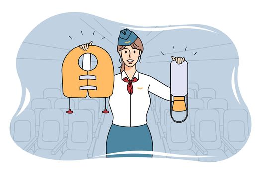 Smiling stewardess showing safety on plane