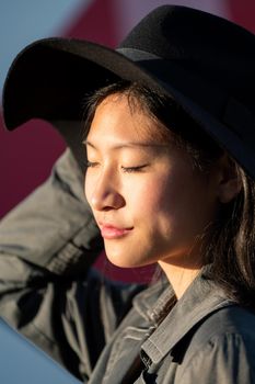 portrait of a young asian woman with eyes closed