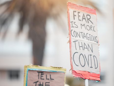 Fear results in control. Cape Town, South African - October 2, 2021 Unrecognisable demonstrators holding up signs and protesting against the Covid 19 vaccine.