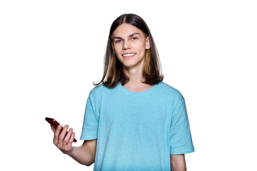 Teenager guy with smartphone in his hands on white isolated background