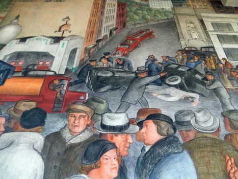 People direct and work on trains in Coit Tower Mural