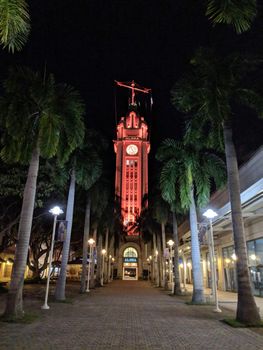 Pathway to Aloha Tower at Night which is light up in red