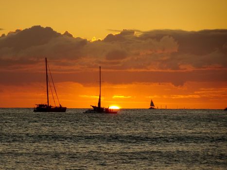 Boats on the pacific ocean waters of Waikiki at Sunset