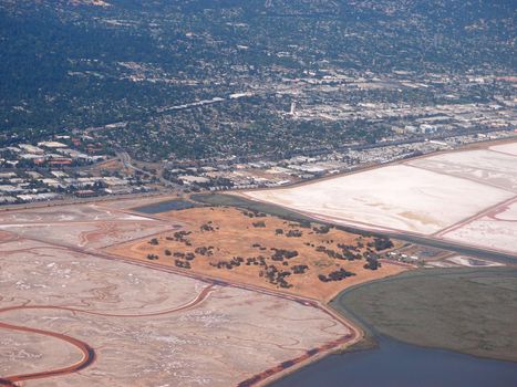 Aerial view of Bedwell Bayfront Park, salt evaporation ponds, cities and nature surrounding San Francisco Bay area