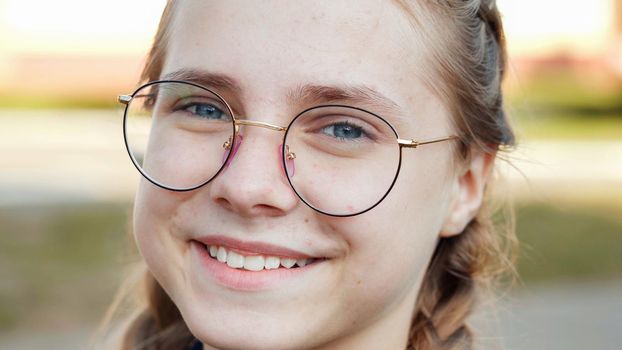 A teenage girl wearing glasses. Close-up of her face.
