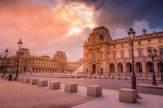 Louvre street lights from Tuileries and dramatic sky, Paris, France