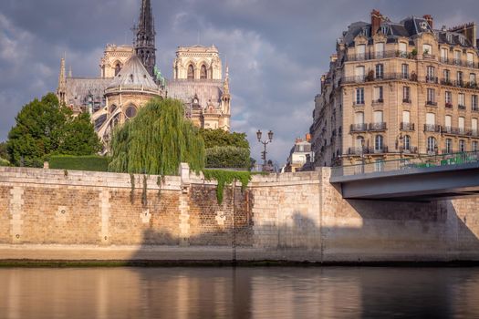Notre Dame of Paris on Seine River at peaceful sunrise, France