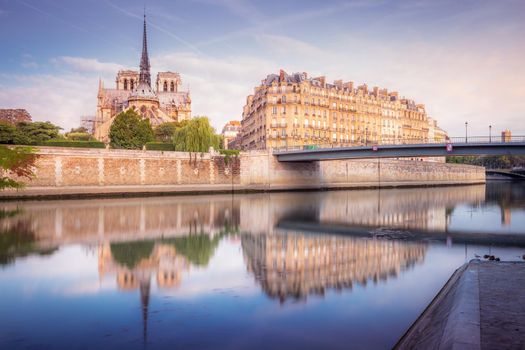 Notre Dame of Paris on Seine River reflection at sunrise, France
