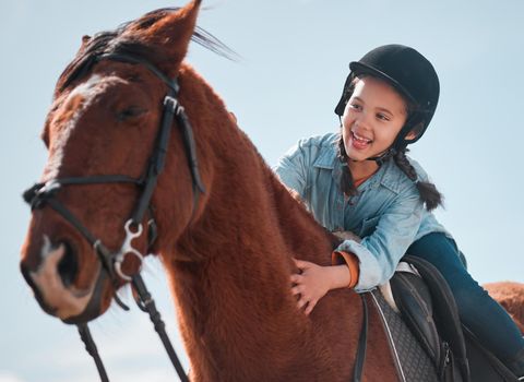 Theres no better adventure than riding a horse. an adorable little girl riding a horse.