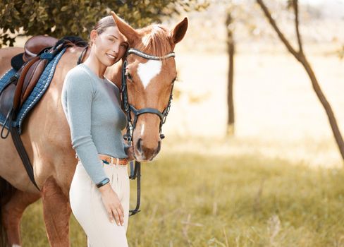 A horse doesnt care how much you know. an attractive young woman standing with her horse in a forest.