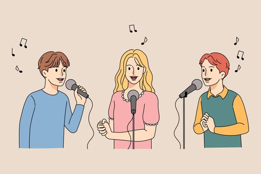 Happy children singing in microphones