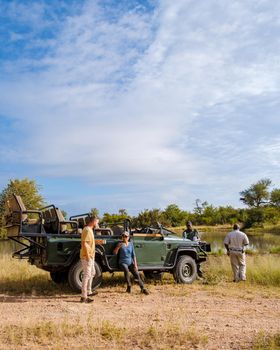 Asian women and European men on safari game drive in South Africa Kruger national park
