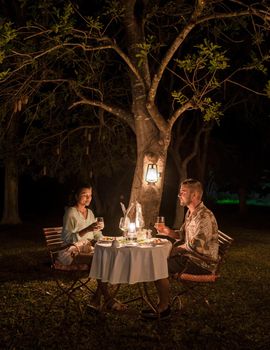 couple on safari in South Africa, Asian women and European men haveng a bush dinner