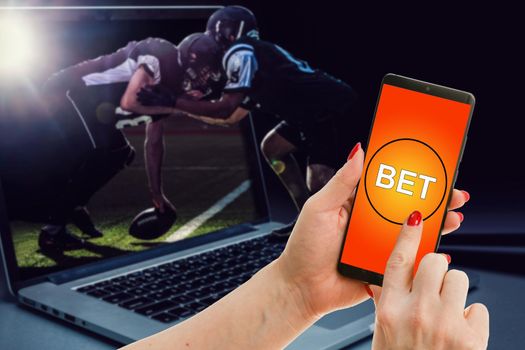 a mobile phone shows a betting application with live results and updates with white background. Online betting concept.