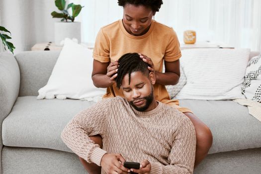 Our connection is all you need. a young couple using a phone at home.