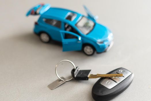 Toy car and keys car on white background