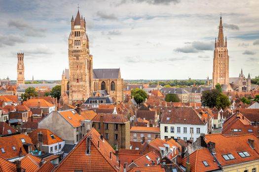 Three towers of Bruges from above with Belfry and Church of our Lady