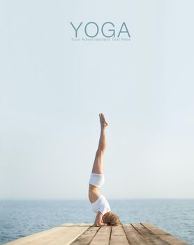 Beautiful blond woman practicing yoga at seashore and meditating