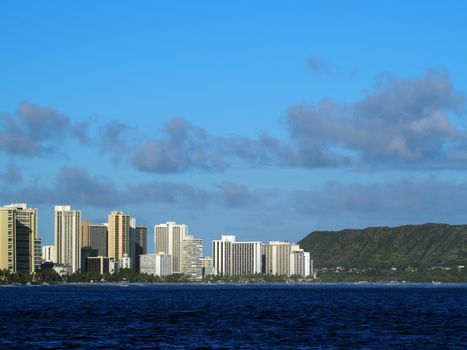 Waikiki Hotels and Diamond Head Crater during the day along the shore seen from the ocean
