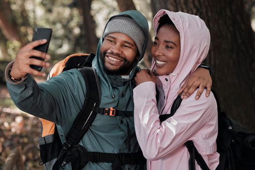 Taking a selfie on our first hike together. a young couple taking a selfie while out on a hike.