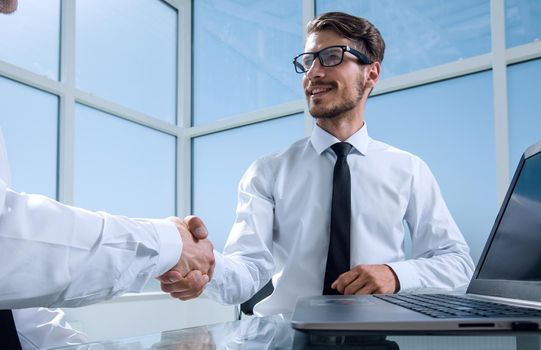 Two young businessmen shaking hands