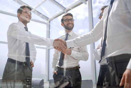 handshake business people in the workplace in the office