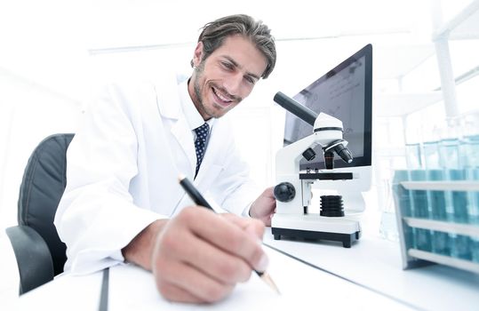 scientist makes a note of experiment in the laboratory