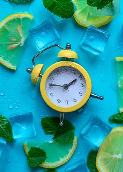 Clock and ice cubes. Vacation and daylight saving time concept. Selective focus.