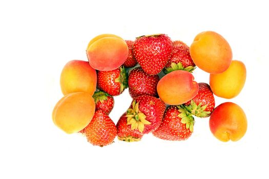 Fresh juicy apricots and sweet strawberries. Warm summer gifts