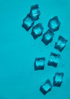 Ice cubes on a blue background. Selective focus.