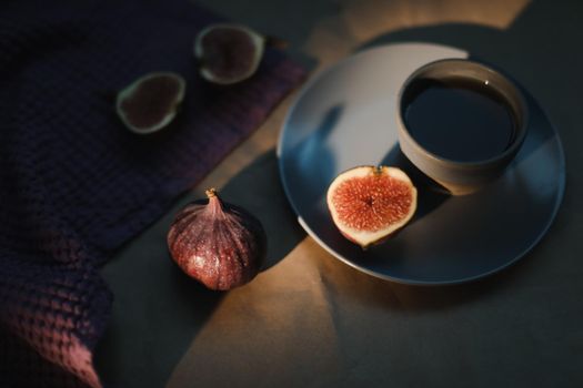 ripe fresh figs and purple textiles on rustic background, flatlay, overhead view