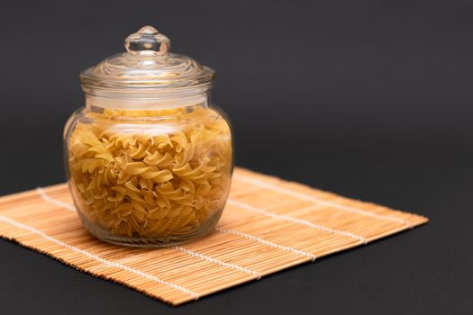 Uncooked Fusilli Pasta in Glass Jar