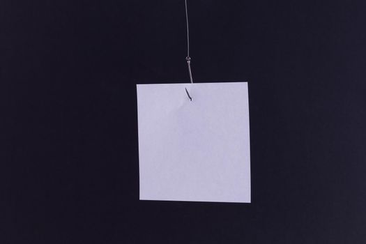 Mockup of a Blank White Memo Paper with Copy Space Hanging on a Fishing Hook