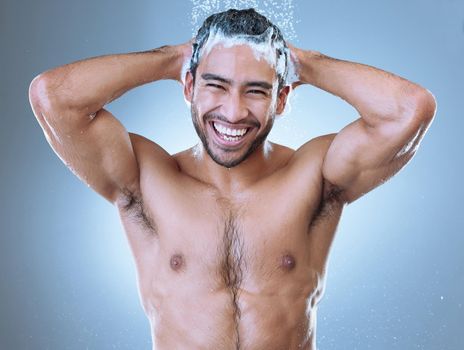 Lighthearted people mean their smiles. Portrait shot of a handsome young man enjoying a shower against a grey background.