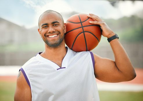 Got game. Cropped portrait of a handsome young male basketball player standing outside with a basketball in hand.