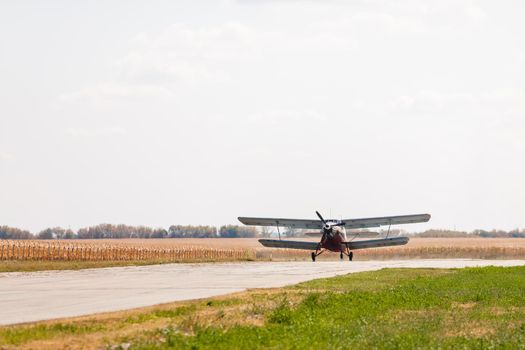 Small light airplane ready to flight on the airport field