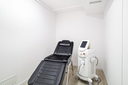 Modern empty dermatologist cosmetologist chair and device for beauty procedures. Empty aesthetic medicine salon in a clinic.