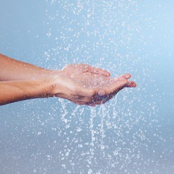 Cleanliness is key for a healthy life. Studio shot of an unrecognisable woman holding her hands under running water against a blue background.