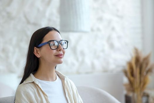 Young beautiful woman in glasses resting with eyes closed, breathing
