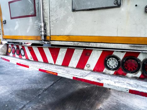 Red and white striped sign of truck rear bumper