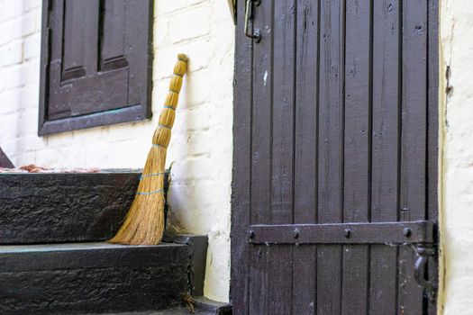 Broom on the threshold of a country house. Broom near the entrance to a house in the countryside.