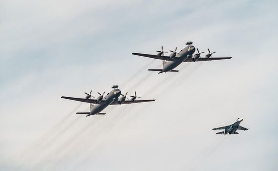 Russia, St. Petersburg, 28 July 2022: Military aircraft and helicopters of the air force fly on the city at the celebration of the Day of the Navy, amphibious and transport aircraft, anti-submarine