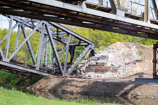 The blown up railway bridge over the Irpen River. War in Ukraine. Panorama. The city of Irpin in the Kyiv region.