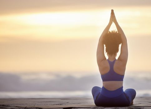 Yoga transforms the person. a unrecognizable female doing yoga on the beach.