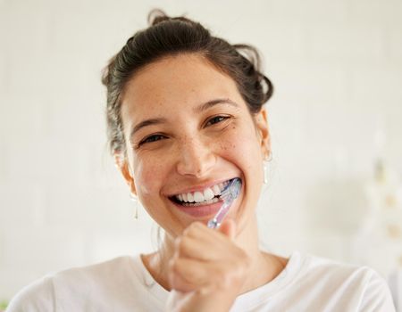 A beautiful smile is easy to achieve. a young woman brushing her teeth.