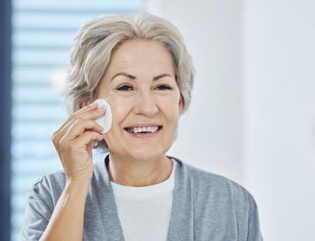 Youre never to old to start a beauty regime. a senior woman going through her skincare routine at home.