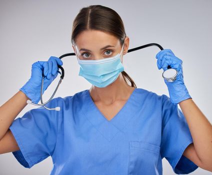 My equipment makes my job simpler. a female nurse removing her stethoscope against a studio background.