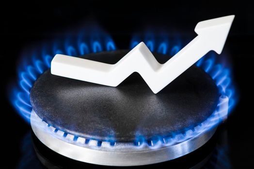 Propane gas price. Supply chains and the energy gas crisis. The concept of gas import and export, transit. Gas stove with burning flame and graph arrow pointing up.