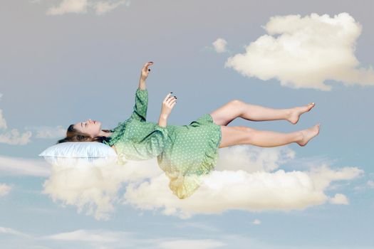 Young relax woman in dress sleeping on pillow in the sky.