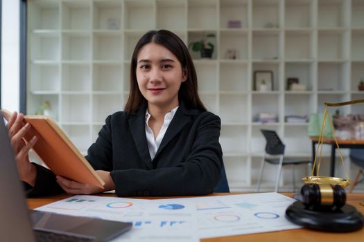 Lawyer business woman working or reading agreement contract in office workplace for consultant lawyer concept.